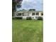 Charming home with a covered front porch, lush lawn, and mature landscaping, creating a welcoming curb appeal at 922 S Lake Reedy Blvd, Frostproof, FL 33843