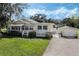 Lovely single-Gathering home with a well-maintained lawn, detached garage, and inviting curb appeal at 922 S Lake Reedy Blvd, Frostproof, FL 33843
