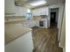 Well-lit kitchen with white cabinets, modern appliances, and wood flooring, perfect for cooking and entertaining at 922 S Lake Reedy Blvd, Frostproof, FL 33843
