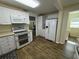 Efficient kitchen with white cabinets, double oven, and modern appliances, providing ample storage and functionality at 922 S Lake Reedy Blvd, Frostproof, FL 33843