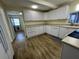 Spacious kitchen featuring white cabinetry, modern appliances, and wood flooring, offering a clean and organized space at 922 S Lake Reedy Blvd, Frostproof, FL 33843