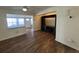 Living room featuring an open floor plan with wood flooring and adjacent sunroom at 922 S Lake Reedy Blvd, Frostproof, FL 33843