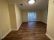 Inviting living room with wood-style flooring and natural light from glass block window at 922 S Lake Reedy Blvd, Frostproof, FL 33843