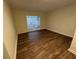 Bright living room features stylish wood flooring and unique glass block window at 922 S Lake Reedy Blvd, Frostproof, FL 33843