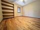 Bedroom with hardwood floors and built-in shelving at 952 N Heron Cir, Winter Haven, FL 33884
