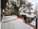 Large deck with lake view and red and white wooden planks at 952 N Heron Cir, Winter Haven, FL 33884