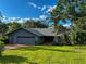 Charming single-story home features a well-manicured lawn, mature trees, and a spacious two-car garage at 952 N Heron Cir, Winter Haven, FL 33884