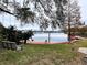 Serene lake view with dock and hanging bench at 952 N Heron Cir, Winter Haven, FL 33884
