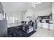 Open living area with grey sectional sofa and kitchen view at 1005 Corvina Dr, Davenport, FL 33897