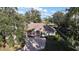 Aerial view of home showcasing landscaping, brick driveway and lake views at 1006 W Lake Hamilton Dr, Winter Haven, FL 33881