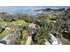Stunning aerial view of lakefront home with lush landscaping and private dock at 1006 W Lake Hamilton Dr, Winter Haven, FL 33881