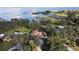 Overhead view of lakefront home with private dock, lush landscaping, and large lawn at 1006 W Lake Hamilton Dr, Winter Haven, FL 33881