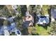 Aerial view of home showcasing roof, backyard, inground pool, and surrounding greenery at 1006 W Lake Hamilton Dr, Winter Haven, FL 33881