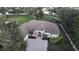 Aerial shot of a home with mature landscaping, brick driveway, white fence and pool at 1006 W Lake Hamilton Dr, Winter Haven, FL 33881