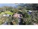 Aerial perspective of a home and its pool, set among mature trees near a lake at 1006 W Lake Hamilton Dr, Winter Haven, FL 33881