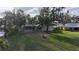 Beautiful backyard featuring a screened pool enclosure and mature landscaping at 1006 W Lake Hamilton Dr, Winter Haven, FL 33881