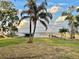 Lush backyard featuring lake access with wooden dock and boat lift at 1006 W Lake Hamilton Dr, Winter Haven, FL 33881