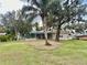 Large backyard with mature trees and a screened pool enclosure at 1006 W Lake Hamilton Dr, Winter Haven, FL 33881