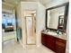Bathroom featuring a granite-topped vanity, large mirror, and glass-enclosed shower at 1006 W Lake Hamilton Dr, Winter Haven, FL 33881