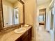 Hall bathroom featuring a framed mirror, single vanity, and tile flooring at 1006 W Lake Hamilton Dr, Winter Haven, FL 33881