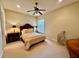 Inviting bedroom featuring a decorative bed, ceiling fan, and neutral carpeting at 1006 W Lake Hamilton Dr, Winter Haven, FL 33881