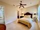 Spacious bedroom with a queen-size bed, nightstands, and ceiling fan at 1006 W Lake Hamilton Dr, Winter Haven, FL 33881