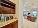 Butler's pantry features dark cabinets, wine racks, and granite countertop at 1006 W Lake Hamilton Dr, Winter Haven, FL 33881
