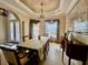 Elegant dining room with tray ceiling, chandelier, and beautiful window treatments at 1006 W Lake Hamilton Dr, Winter Haven, FL 33881
