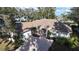 Aerial view of a lovely home with mature landscaping, brick driveway and attached two-car garage at 1006 W Lake Hamilton Dr, Winter Haven, FL 33881