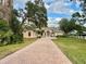 Charming home with a circular driveway and manicured front yard at 1006 W Lake Hamilton Dr, Winter Haven, FL 33881