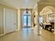 Bright foyer featuring tile flooring, decorative doors, columns and an adjacent dining room at 1006 W Lake Hamilton Dr, Winter Haven, FL 33881