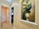 Hallway featuring a peacock mural on the wall in an alcove, decorative paint and natural light at 1006 W Lake Hamilton Dr, Winter Haven, FL 33881