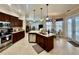 Open kitchen with granite countertops, stainless appliances, and breakfast nook with natural light at 1006 W Lake Hamilton Dr, Winter Haven, FL 33881