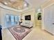 Bright living room boasts tile floors, neutral sofa, access to lanai, and tray ceiling at 1006 W Lake Hamilton Dr, Winter Haven, FL 33881