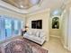 Comfortable living room featuring a tile floor, neutral sofa, lanai access, and tray ceiling at 1006 W Lake Hamilton Dr, Winter Haven, FL 33881