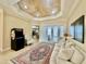 Large living room featuring a tile floor, tray ceiling, lanai access, and a game console at 1006 W Lake Hamilton Dr, Winter Haven, FL 33881