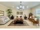 Bright living room featuring elegant chandelier, neutral colors, and plush seating arrangement at 1006 W Lake Hamilton Dr, Winter Haven, FL 33881