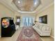 Spacious living room featuring a tile floor, tray ceiling, lanai access, and a game console at 1006 W Lake Hamilton Dr, Winter Haven, FL 33881