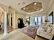 Bright living room features tray ceiling, tile floors, french doors and decorative rug at 1006 W Lake Hamilton Dr, Winter Haven, FL 33881