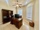Bright home office features built-in shelving, ceiling fan, and a large work desk at 1006 W Lake Hamilton Dr, Winter Haven, FL 33881
