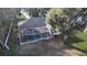 Aerial view of a private screened in pool area with lush greenery at 1006 W Lake Hamilton Dr, Winter Haven, FL 33881