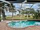 Screened pool with brick trim and lake view at 1006 W Lake Hamilton Dr, Winter Haven, FL 33881