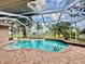 Screened-in pool area with brick paver decking, overlooks backyard and lake at 1006 W Lake Hamilton Dr, Winter Haven, FL 33881