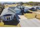 Aerial view of a well-maintained home with mature landscaping, long driveway and carports at 1027 Bradbury Rd, Winter Haven, FL 33880