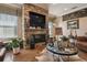 Inviting living room featuring a stone fireplace with TV and rustic decorative accents at 1027 Bradbury Rd, Winter Haven, FL 33880