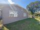 View of a spacious backyard with healthy green grass and chainlink fence at 108 Prospect Ave, Winter Haven, FL 33880