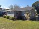 View of a spacious backyard with healthy green grass and chainlink fence at 108 Prospect Ave, Winter Haven, FL 33880