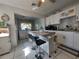 Updated kitchen with tile backsplash, island with seating, and view to the adjacent utility room at 108 Prospect Ave, Winter Haven, FL 33880