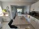 Kitchen view with island, white cabinets, and updated backsplash with a view into the laundry area at 108 Prospect Ave, Winter Haven, FL 33880