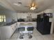 Updated kitchen featuring granite countertops, an island with seating, and stainless steel appliances at 108 Prospect Ave, Winter Haven, FL 33880